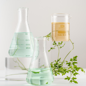 Scientific beakers filled with green and yellow liquid