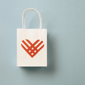 Charitable white bag with a red heart on it
